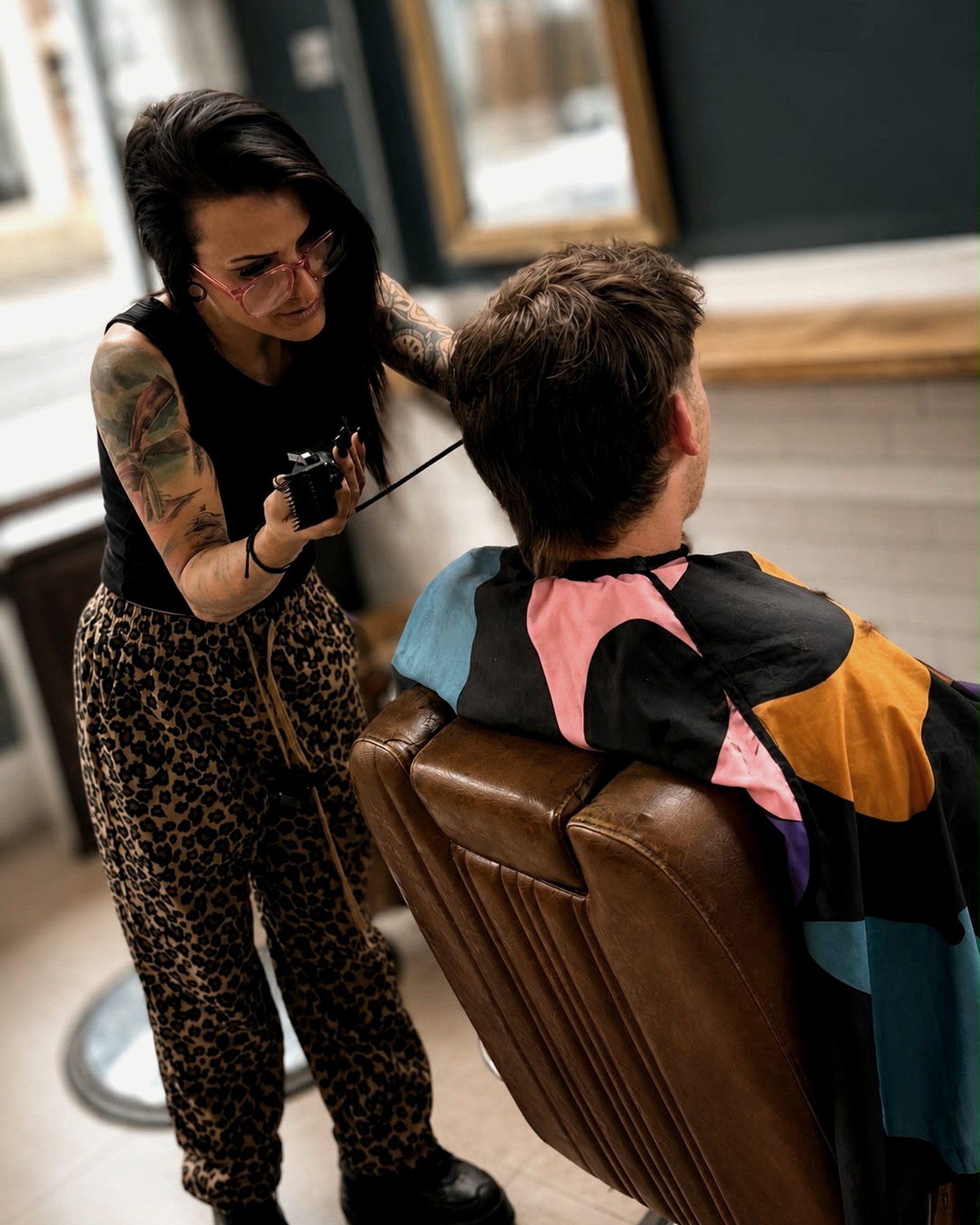 Carley barbering at The Village Barber Shop